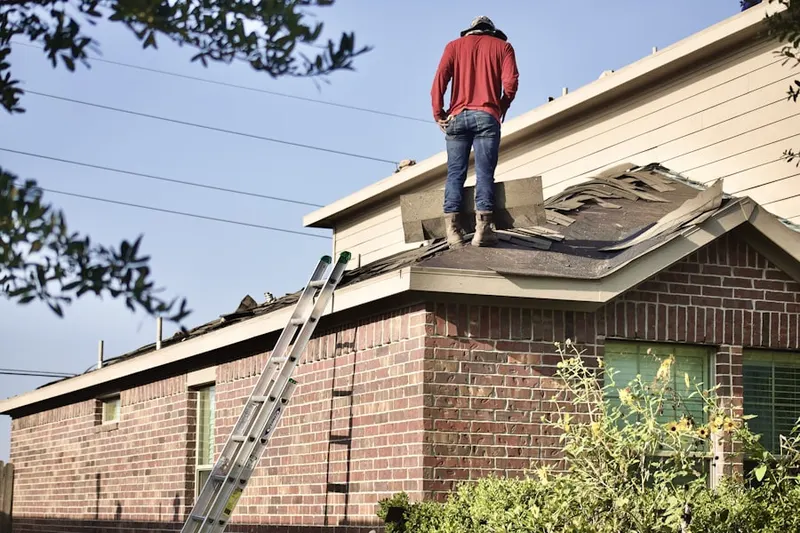 Professional roofer working on a residential roof in Bush Hill Woods
